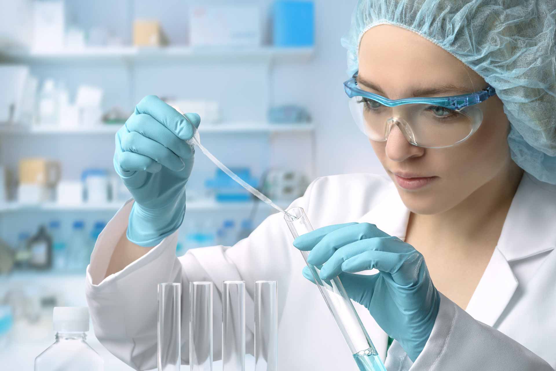 female scientist in laboratory filling beaker